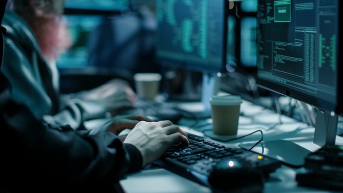 Close-up shot of a hacker using a keyboard.